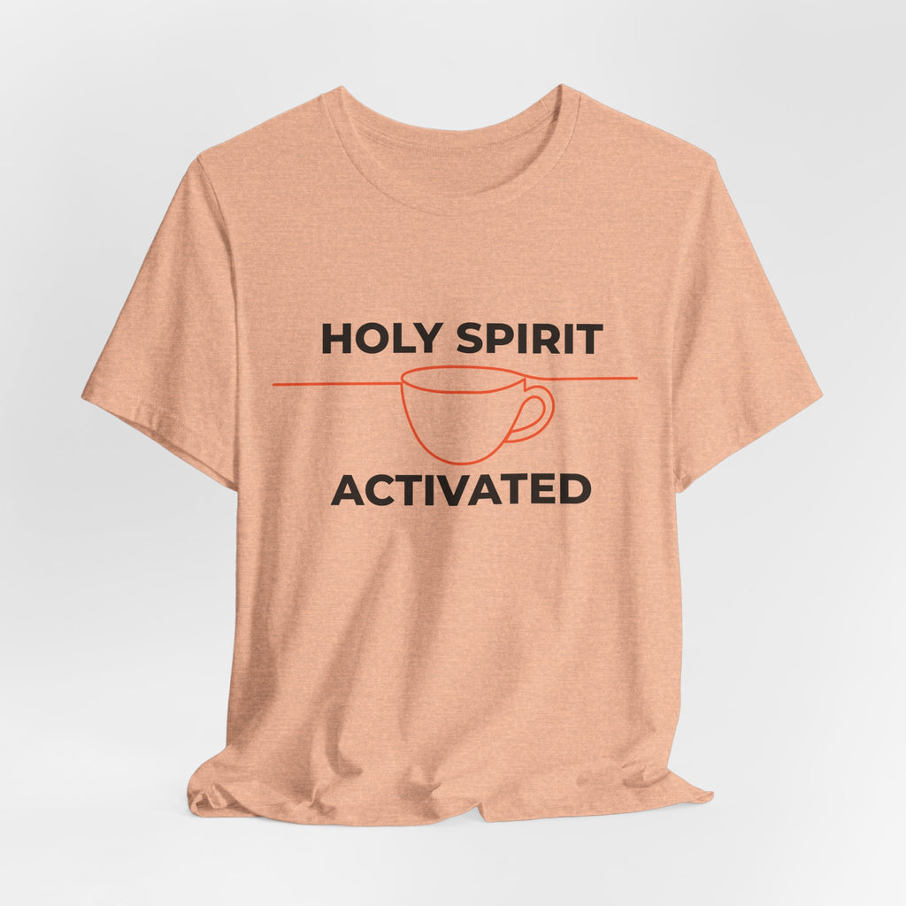 Peach-colored t-shirt with 'Holy Spirit Activated' text and coffee cup graphic on a light gray background