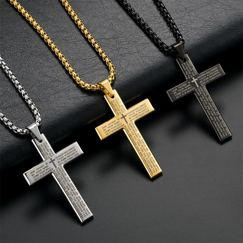 Three cross necklaces in gold, silver, and black on a dark surface