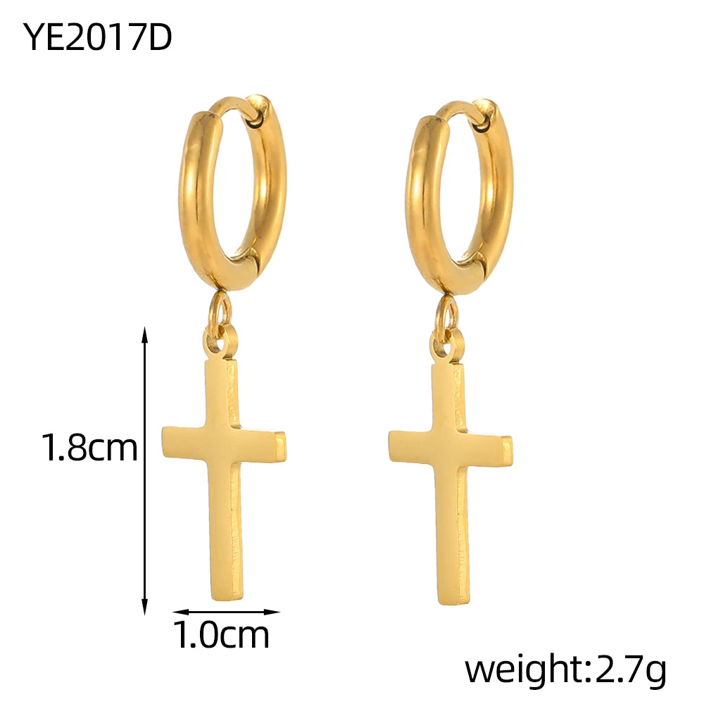 Gold hoop earrings with cross pendants on a white background