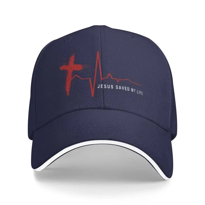 Navy blue cap with red cross and heartbeat design with 'Jesus Saved My Life' on a white background