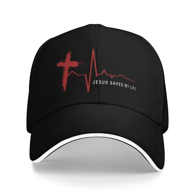 Black cap with red cross and heart rate line design, featuring 'Jesus Saved My Life' text on a white background.