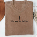 Brown t-shirt with 'His way is better' text and cross symbol on a white background