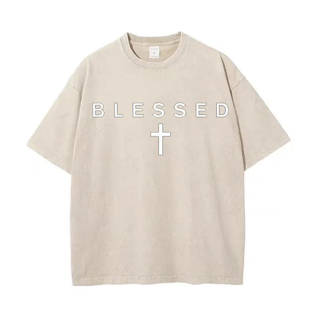Beige t-shirt with 'BLESSED' text and cross on a white background