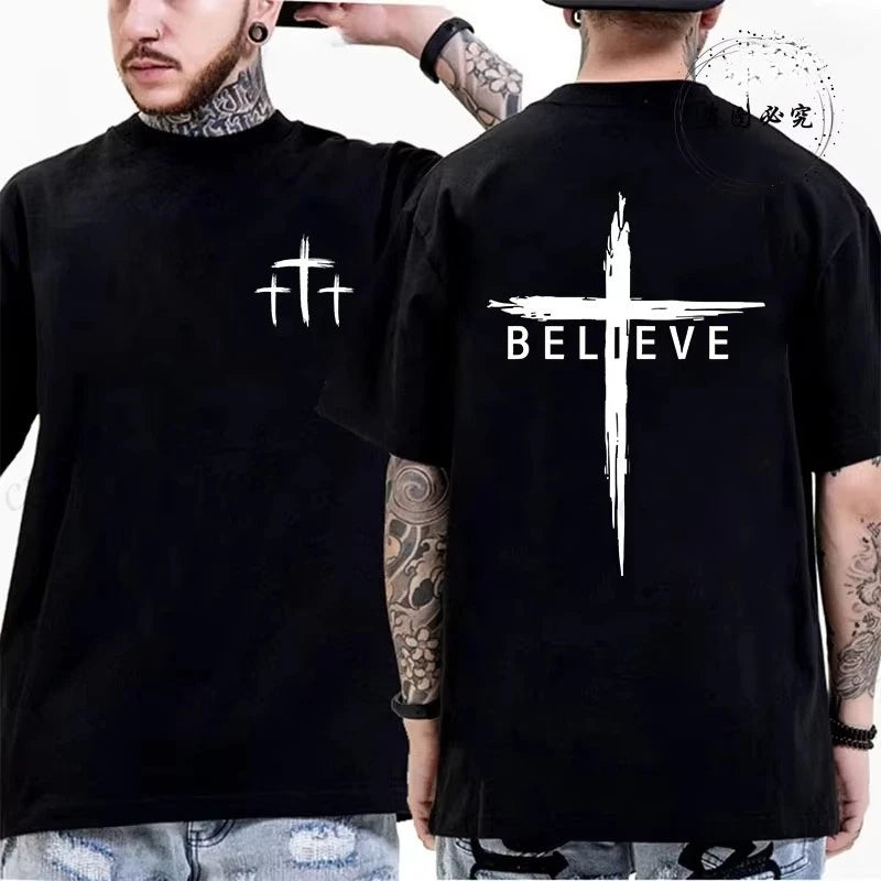 Two people wearing black t-shirts with cross designs, one on the front and one on the back with 'BELIEVE' text.