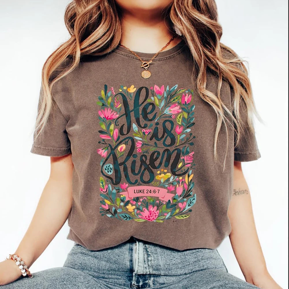 Person wearing a brown t-shirt with floral text design and denim jeans on a white background