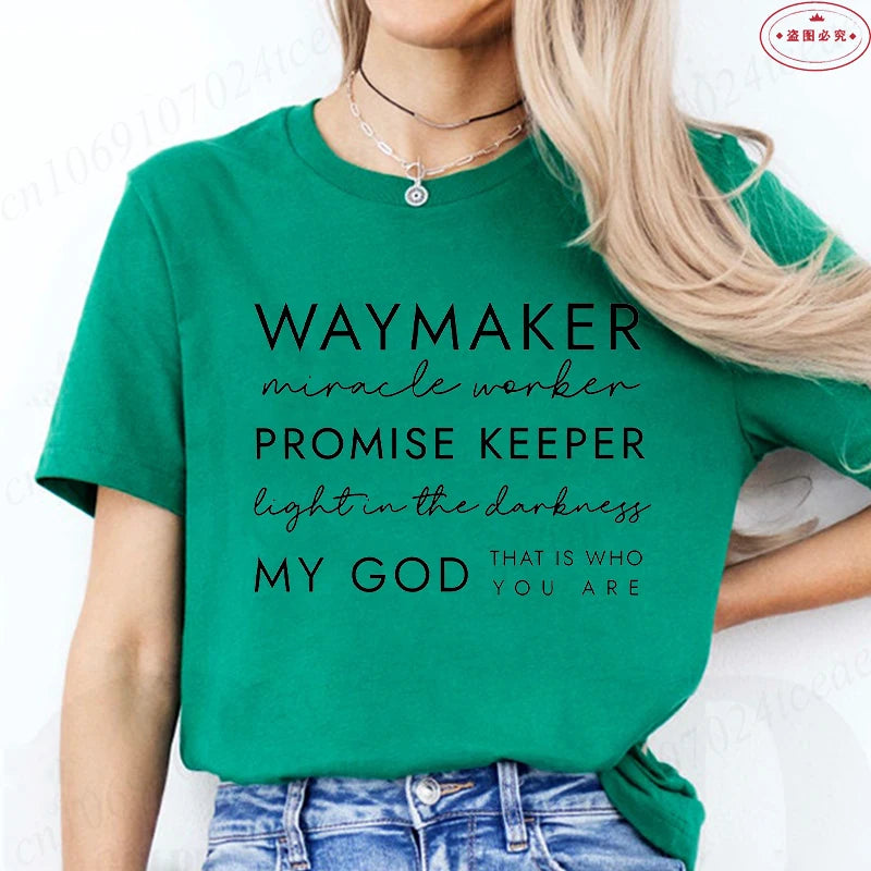 Person wearing a green t-shirt with motivational text on a white background