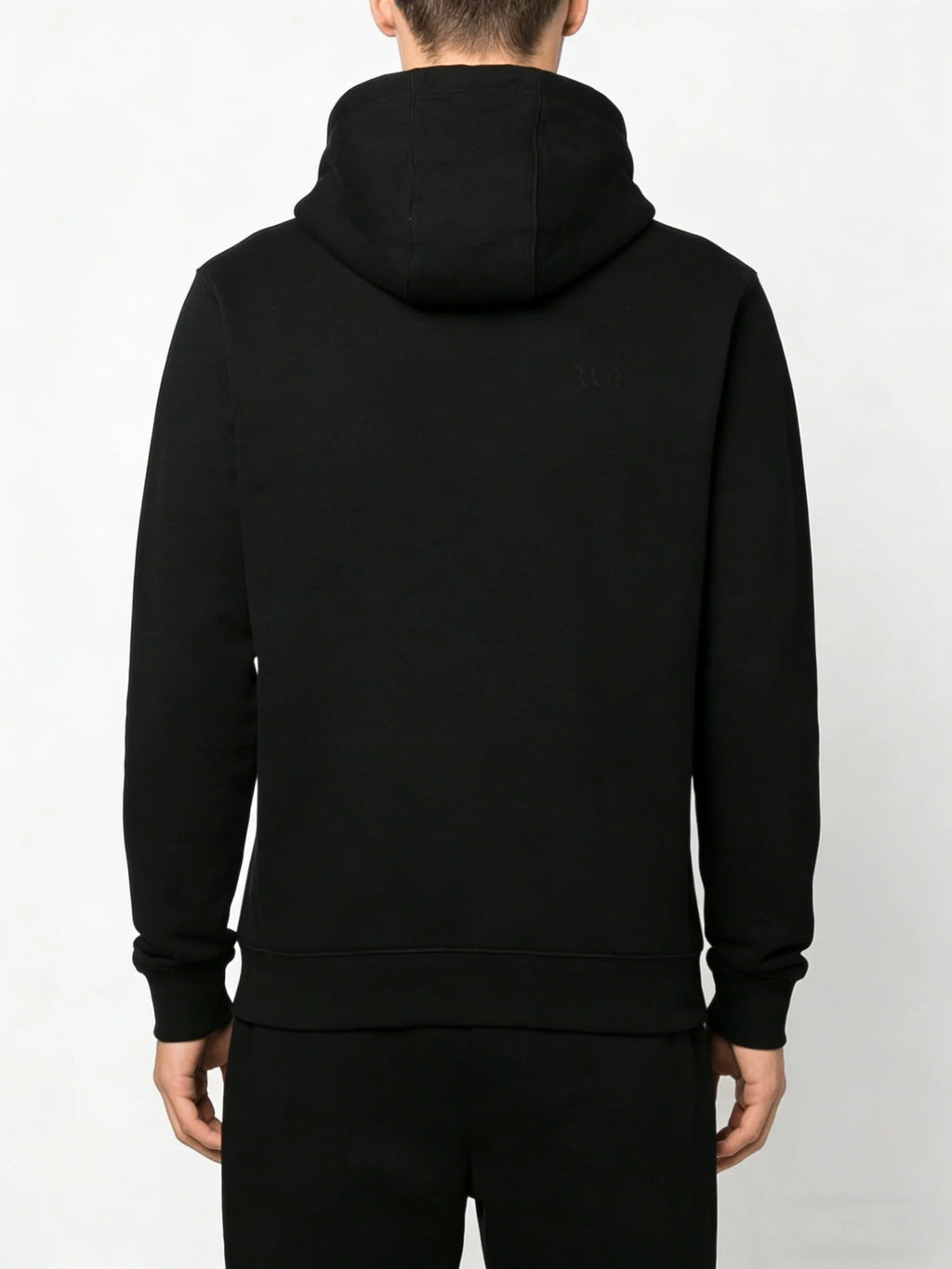 Black hoodie worn by a person on a light gray background