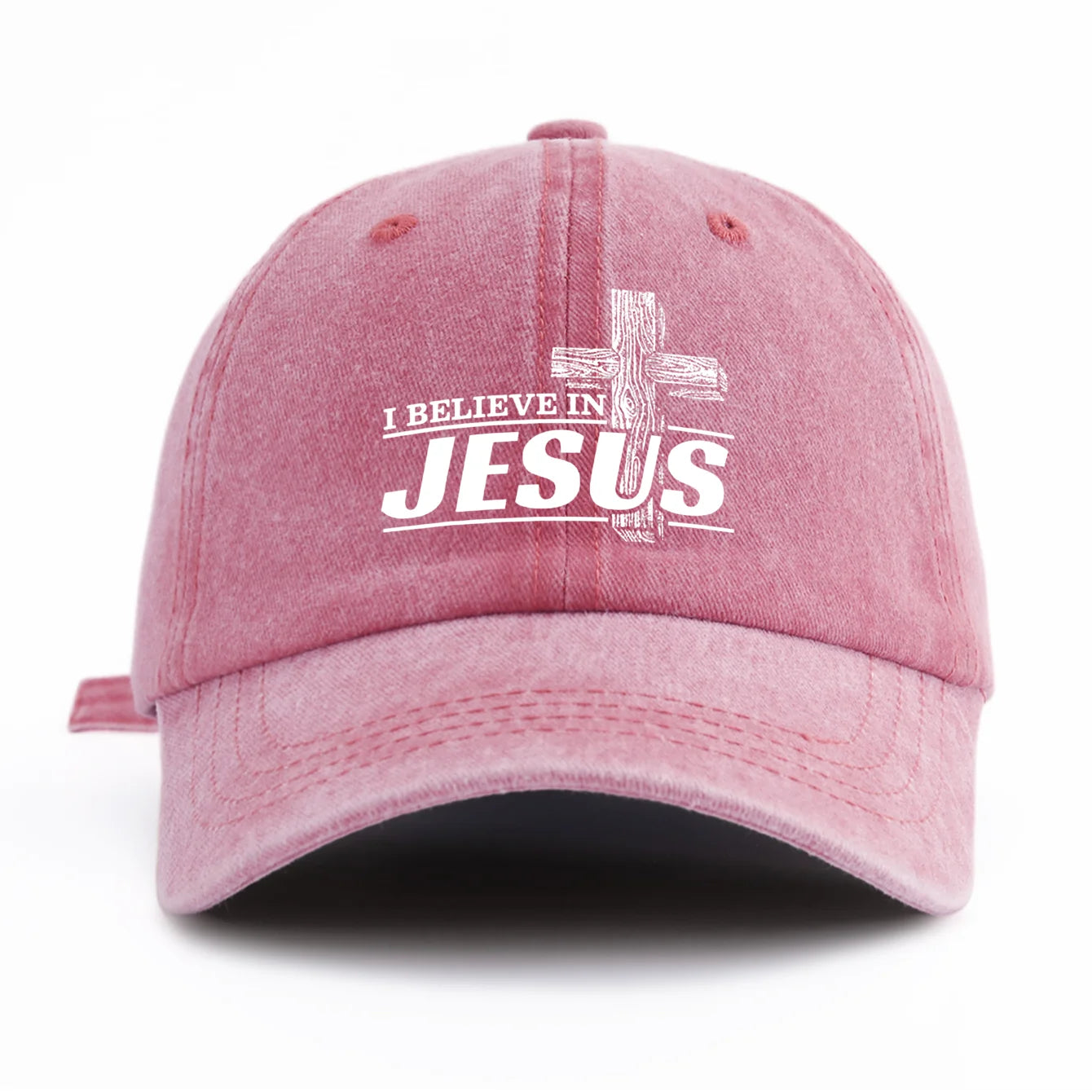 Pink cap with 'I Believe in Jesus' text on a white background