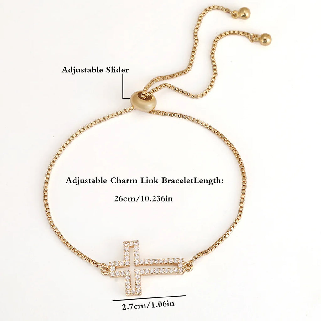 Gold bracelet with a cross charm and adjustable slider on a white background