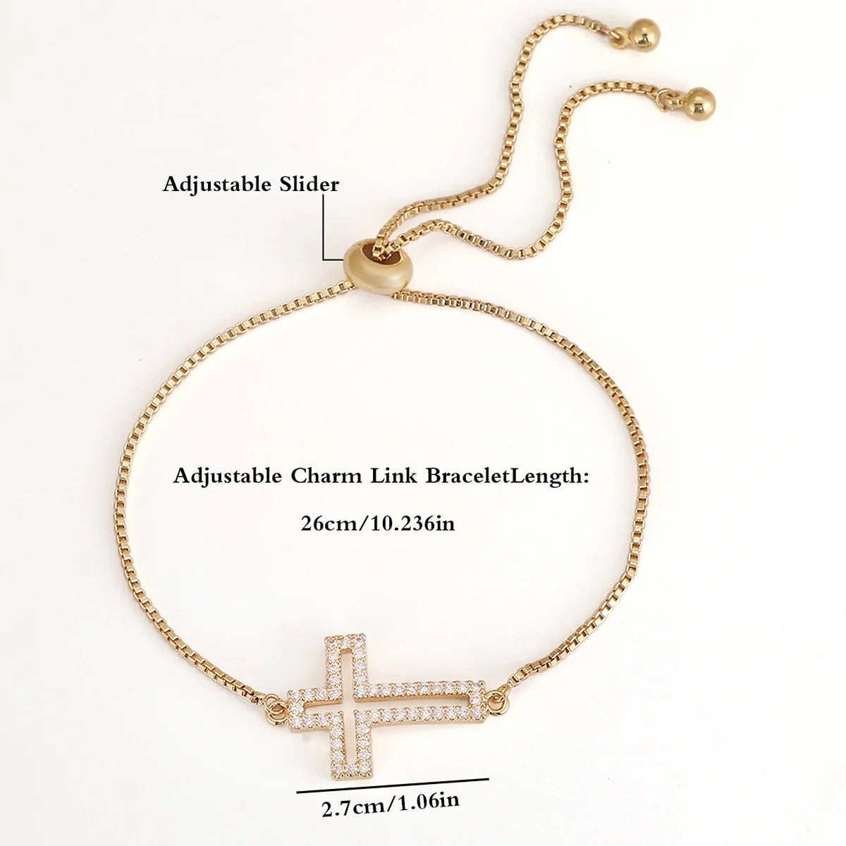Gold bracelet with a cross charm and adjustable slider on a white background