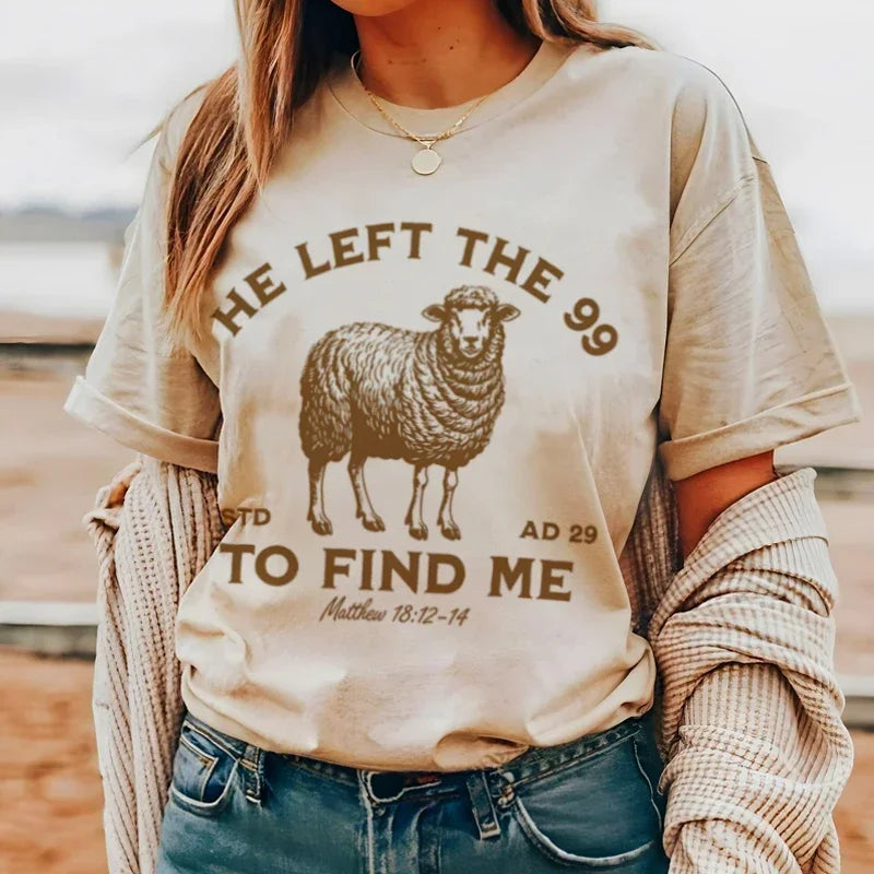 Person wearing a beige t-shirt with a sheep graphic and text.