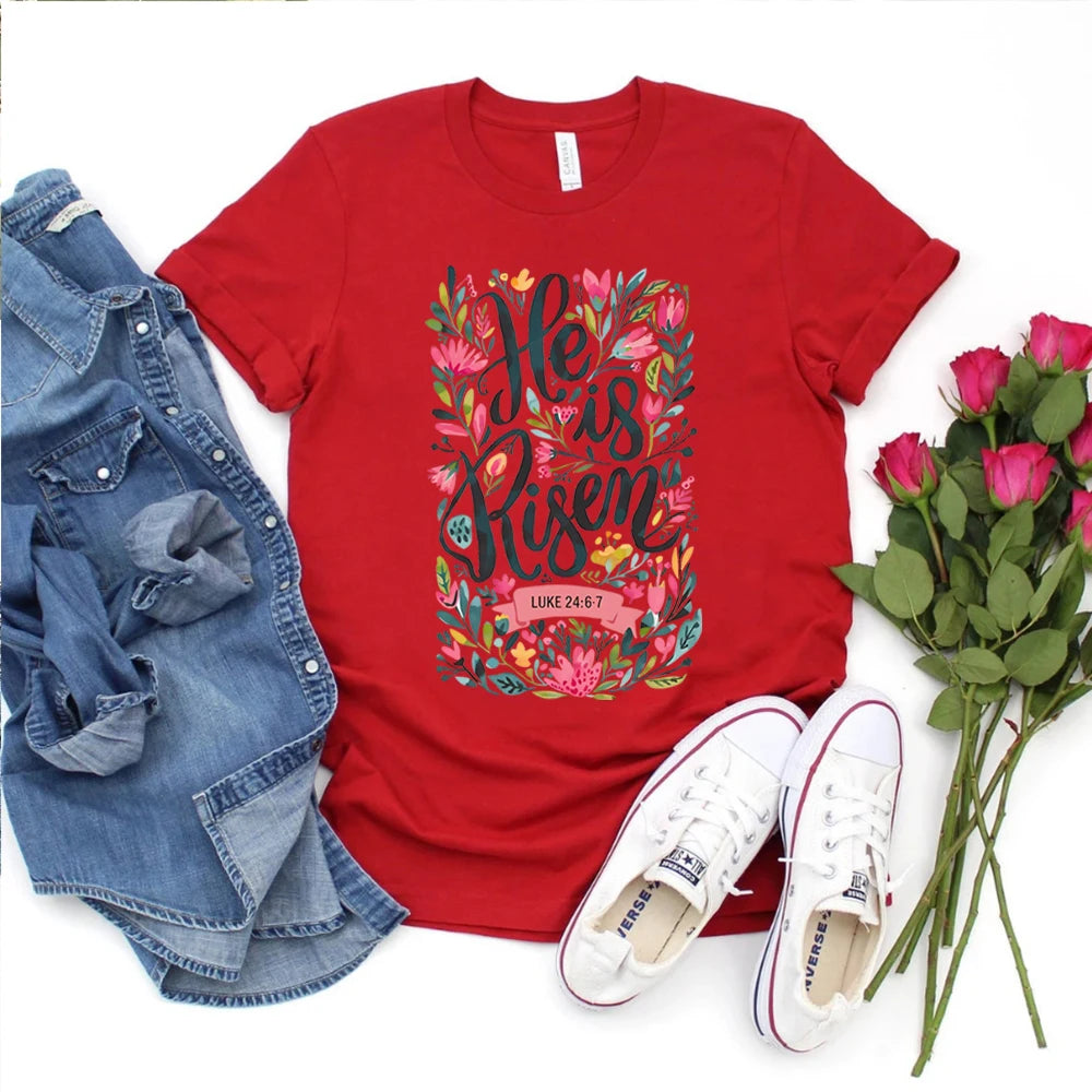 Red t-shirt with floral text design, denim jacket, white sneakers, and pink roses on a white background