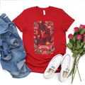 Red t-shirt with floral text design, denim jacket, white sneakers, and pink roses on a white background