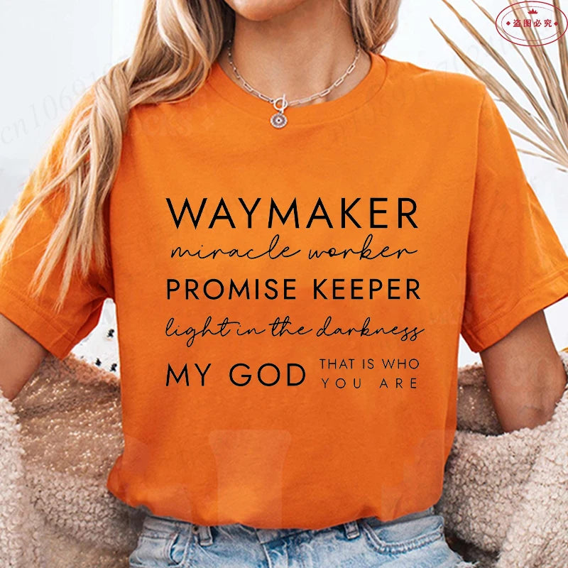 Person wearing an orange t-shirt with motivational text