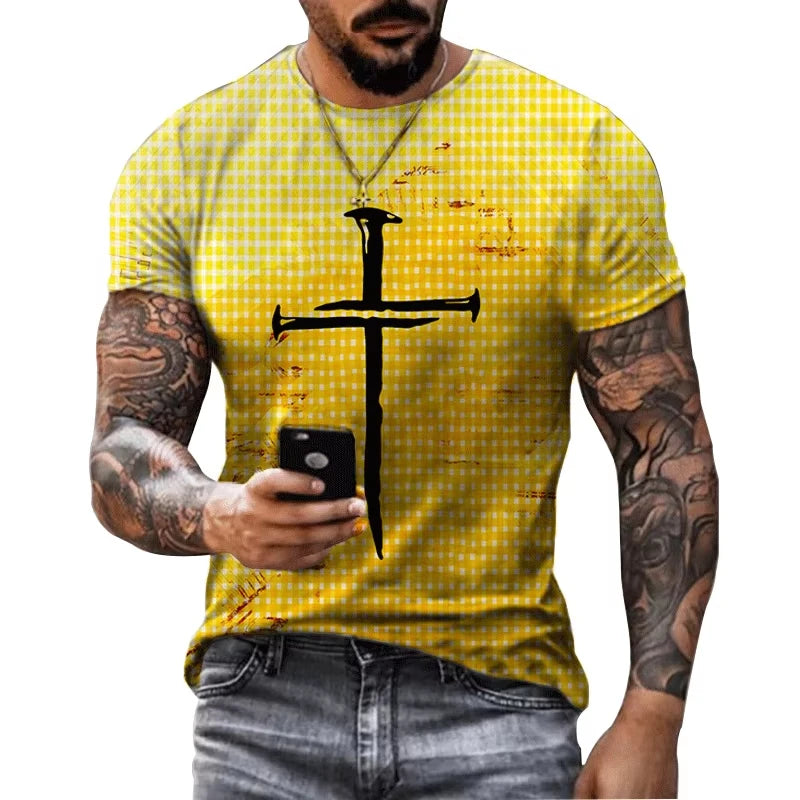 Man wearing a yellow checkered t-shirt with a black cross design, holding a phone.