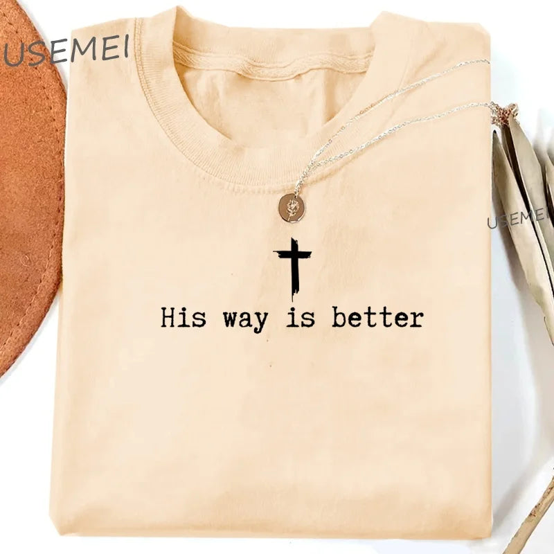 Beige shirt with 'His way is better' text and cross pendant on a white background
