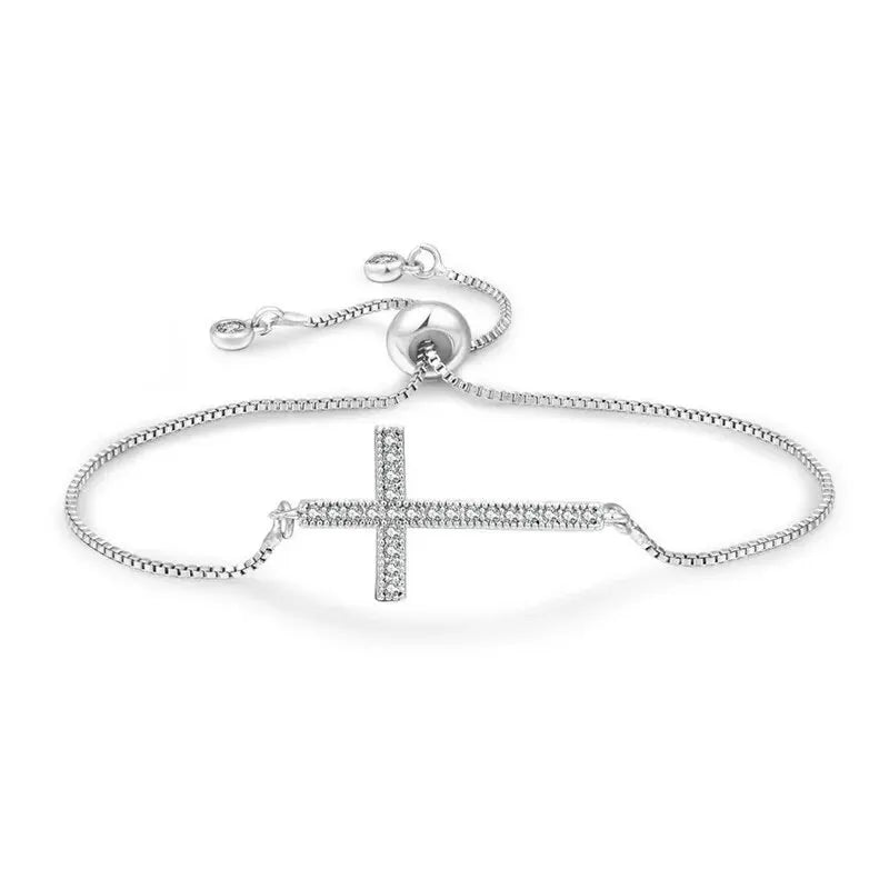 Silver bracelet with a cross design on a white background