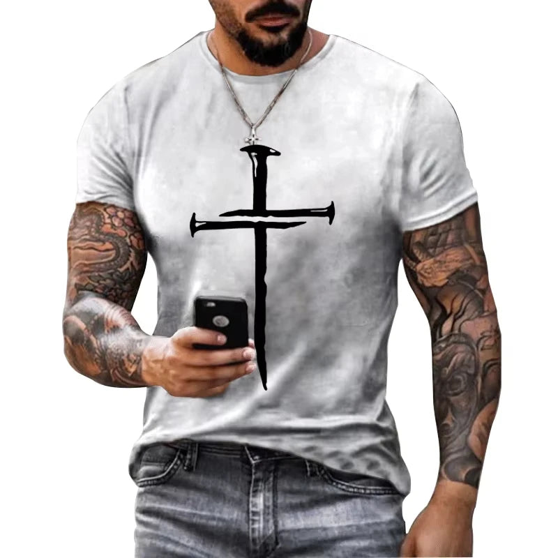 Man wearing a white t-shirt with a black cross design, holding a phone.