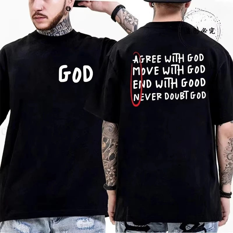 Two people wearing black t-shirts with religious text, one on the front and one on the back.