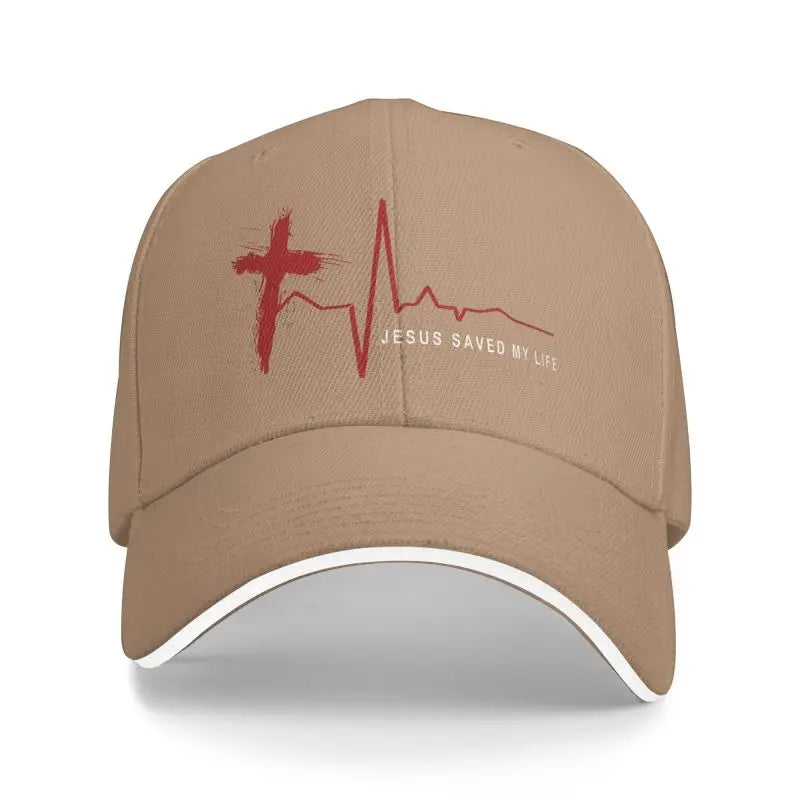 Brown cap with red cross and heartbeat design, featuring 'Jesus Saved My Life' text on a white background.